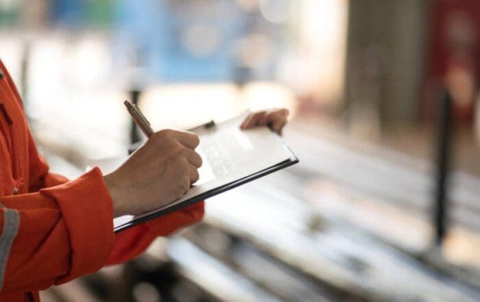 Worker taking notes for an after-action review.