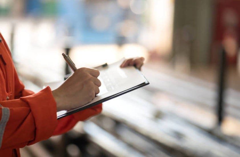Worker taking notes for an after-action review.