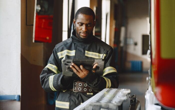 A firefighter updating their department's accountability system.