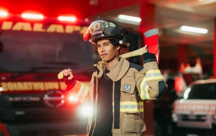A firefighter equipped with a distinct helmet shield for identification.